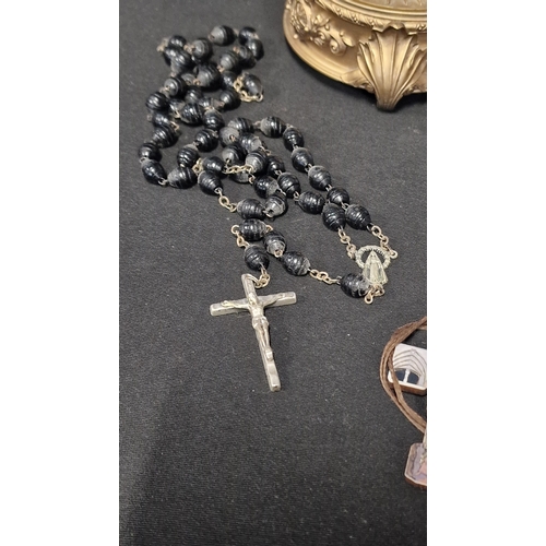 51 - A selection of religious items including 3 sets of rosary beads, and crucifixes