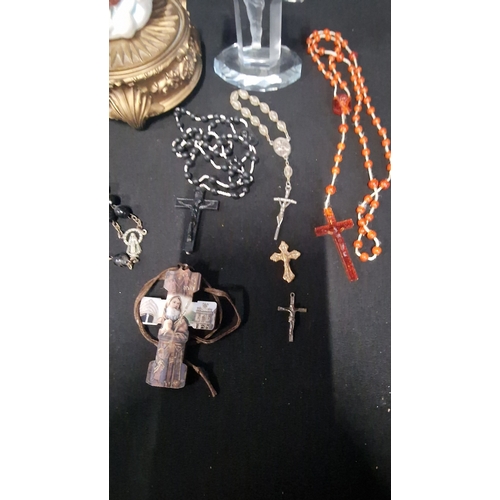 51 - A selection of religious items including 3 sets of rosary beads, and crucifixes