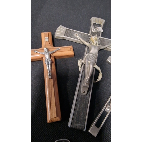 52 - Three vintage metal and wooden crucifixes.