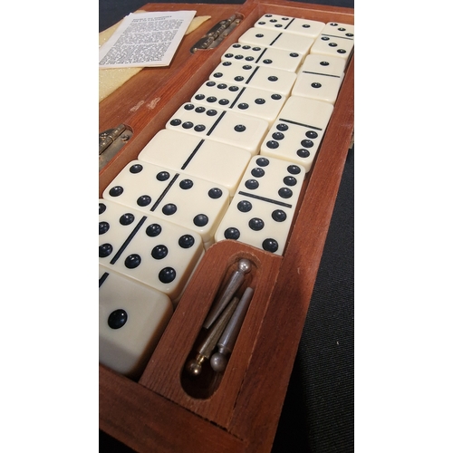 64 - A vintage boxed set of double sixes dominoes and cribbage board.