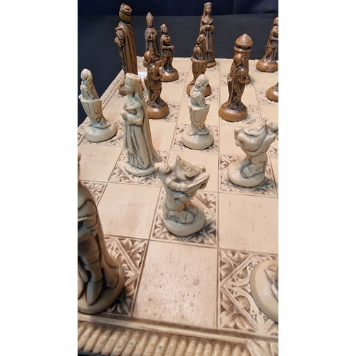 76 - A medieval style chess set and board in resin.