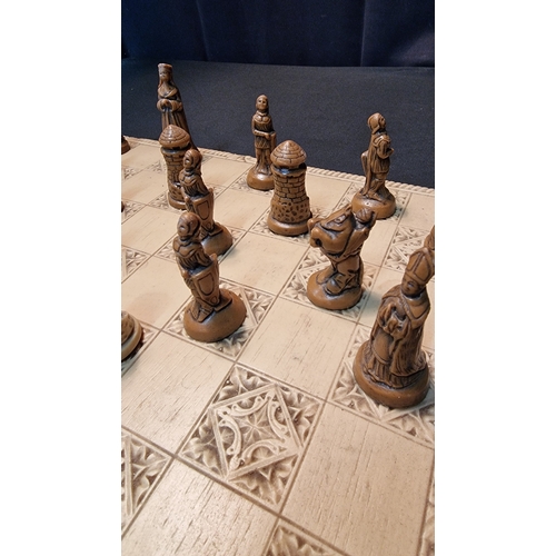 76 - A medieval style chess set and board in resin.