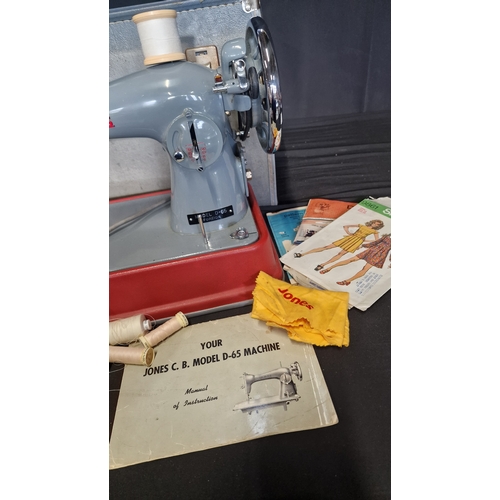 145 - A vintage JONES sewing machine Model D-65. Comes with pedal, manual and original dust cloth.