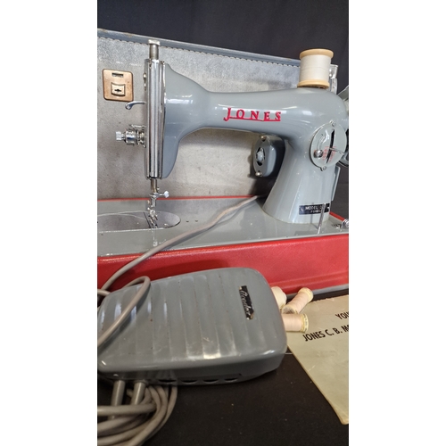 145 - A vintage JONES sewing machine Model D-65. Comes with pedal, manual and original dust cloth.