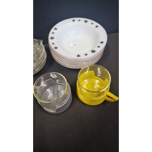 149 - A collection of vintage glass kitchen ware.  Two glass lemon squeezers and Pyrex cups and six white,... 