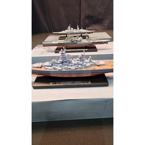 209 - Three collectable model ships.  HMS Repulse, Prinz Eugen and USS Missouri.