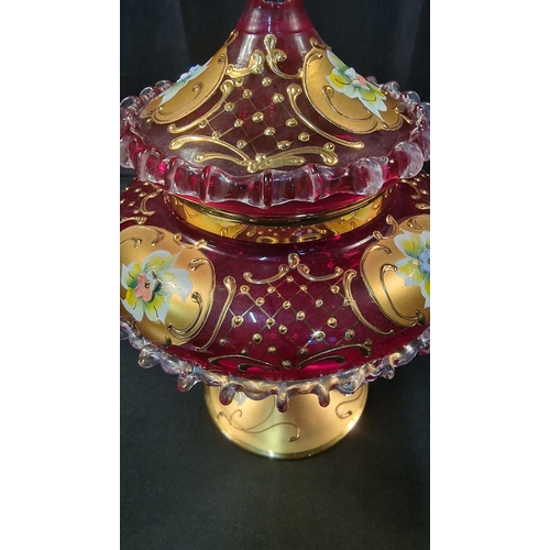 242 - A stunning piece of cranberry glass with gold and floral finish