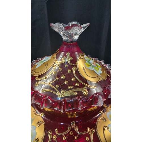 242 - A stunning piece of cranberry glass with gold and floral finish