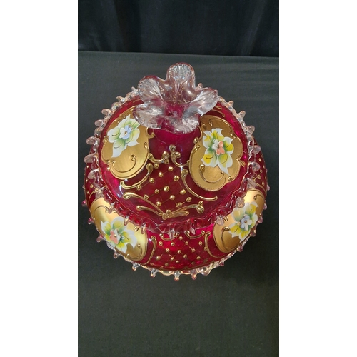 242 - A stunning piece of cranberry glass with gold and floral finish