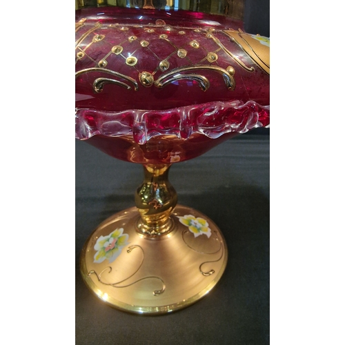 242 - A stunning piece of cranberry glass with gold and floral finish