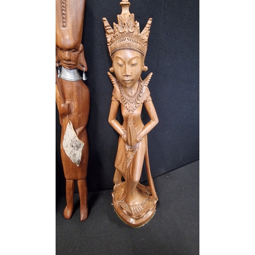 312 - Three hand carved figures of mixed woods.  An Indonesian lady, and two tribal figures