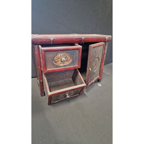 313 - A wooden Tibetan style storage cabinet 41 L x 29 H x 14 cm W