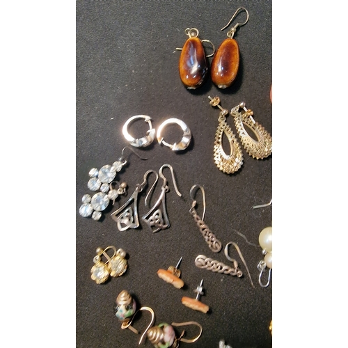 424 - Approximately 20 pairs of costume and sterling silver earings.