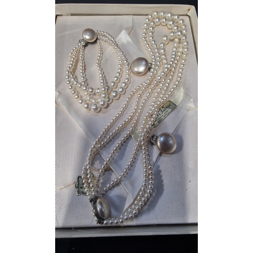 429 - A set of three vintage pearl necklaces along with an earing, bracelet and necklace set