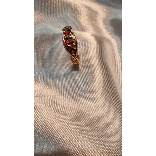 432 - Diamond and ruby 18ct 750 gold ring
Weight 2.1g approximately 
Size O