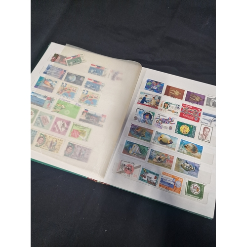 12 - A vintage stamp album containing Philippines stamps