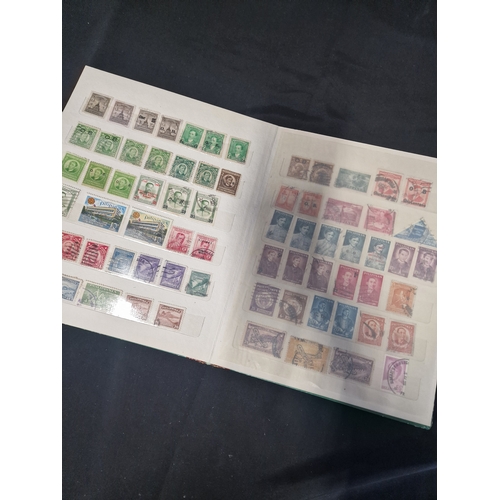 12 - A vintage stamp album containing Philippines stamps