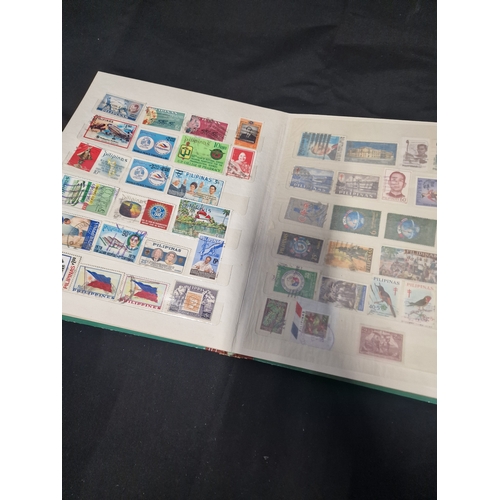 12 - A vintage stamp album containing Philippines stamps