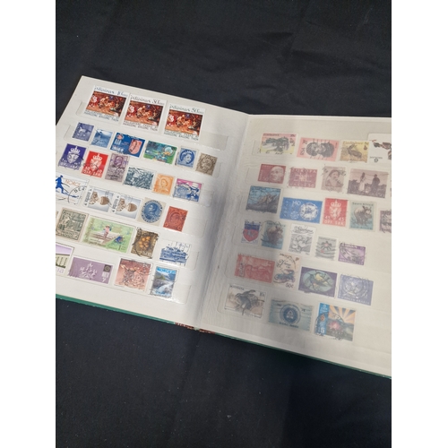 12 - A vintage stamp album containing Philippines stamps