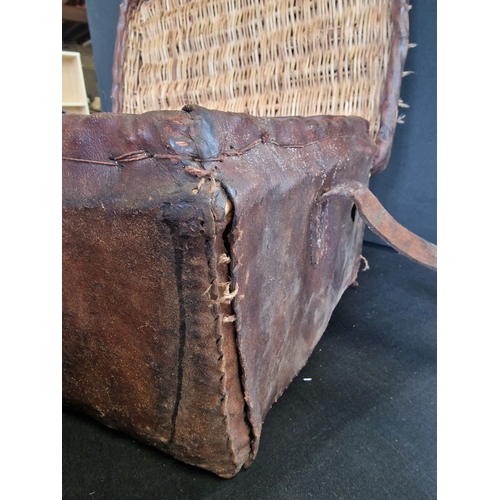 72 - A antique leather bound wicker picnic basket