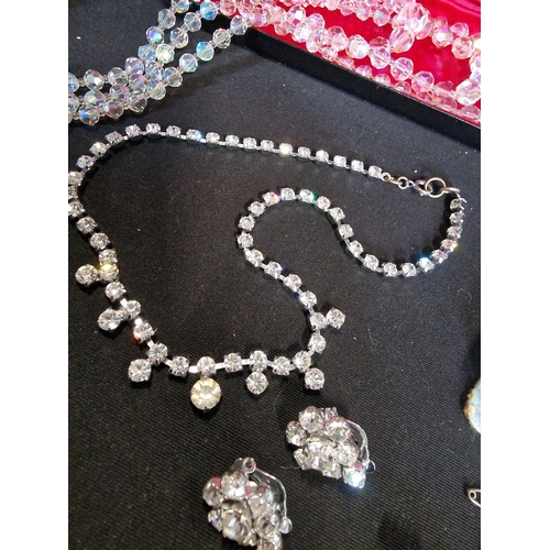 229 - Four piece of vintage costume jewellery, necklaces, clip on earings and brooche.