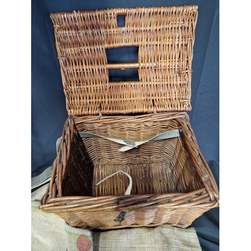 242 - A vintage fishing basket with two hessian sacks