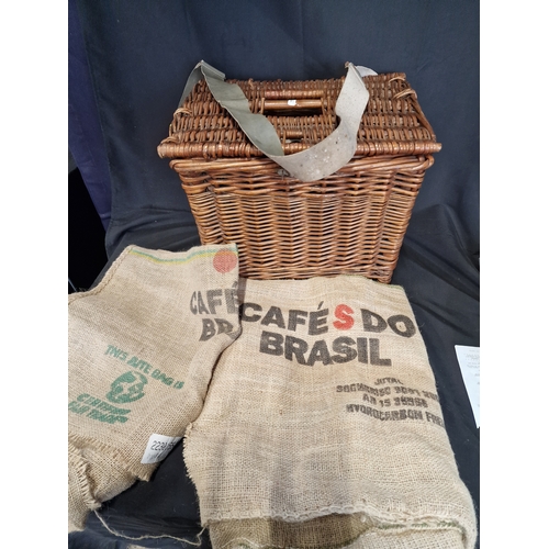 242 - A vintage fishing basket with two hessian sacks