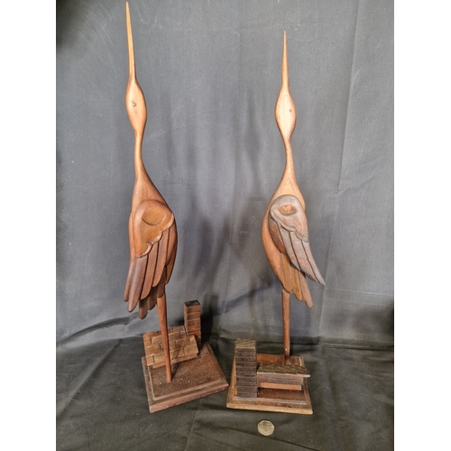 353 - Two hand made wooden storks on roof top.  Approximately 65cm H