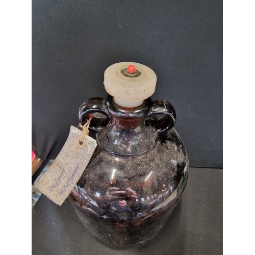 389 - A brown glass demijohn