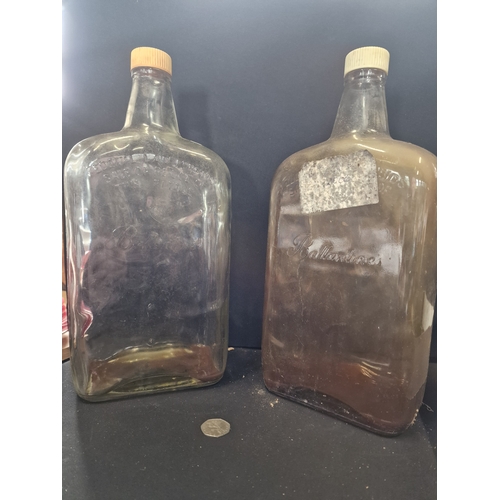 390 - Two large glass storage bottles with inscriptions 'federal law forbids the sale or reuse of this bot... 