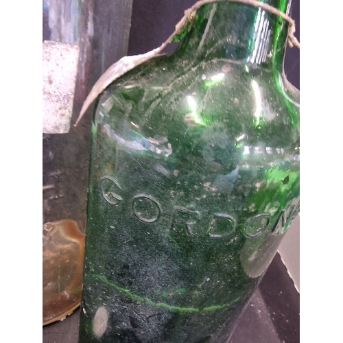 391 - A vintage Scotich whiskey bottle and large Gordon's gin bottle