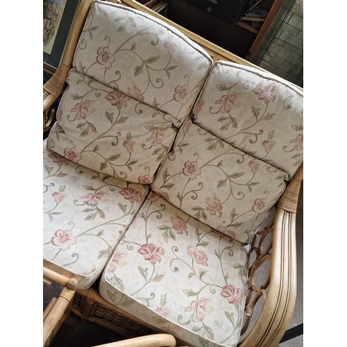 392 - Three piece conservatory set.  Two seater sofa, table and foot stool.