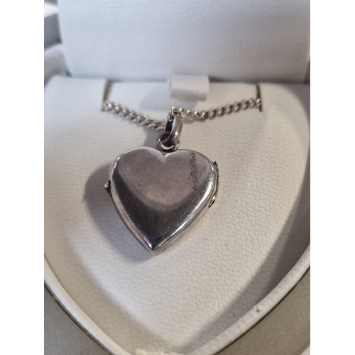 418 - Sterling silver heart locket pendant and chain.