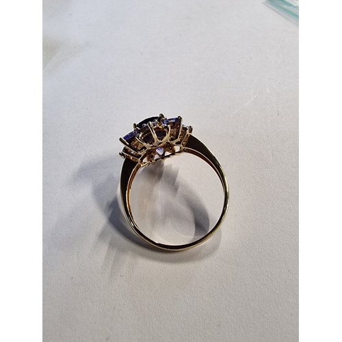 425 - Purple glass floral design ring set in 9ct gold 
Size R/S Approximately 3.61g