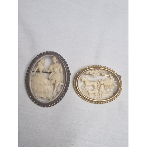 12 - Two gold coloured Celio style brooches.