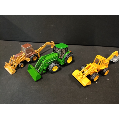 58 - A model John Deere tractor and 2 digger models from Siku, ERTL and Maisto