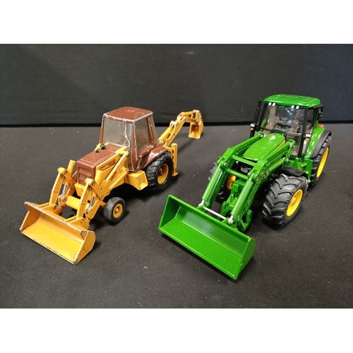 58 - A model John Deere tractor and 2 digger models from Siku, ERTL and Maisto