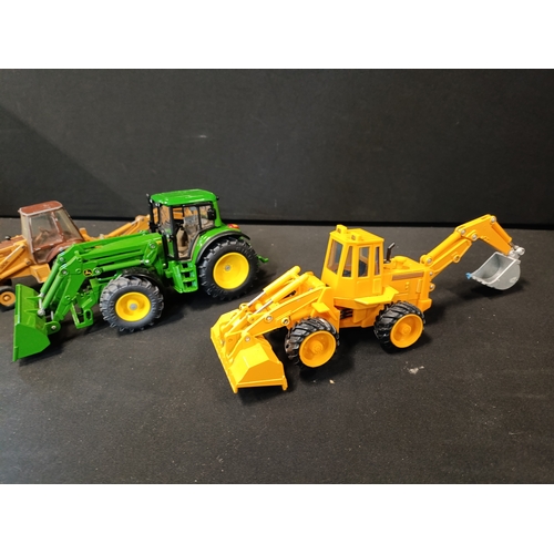 58 - A model John Deere tractor and 2 digger models from Siku, ERTL and Maisto