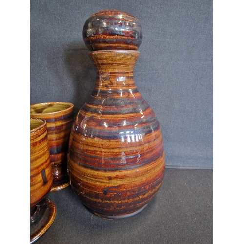 61 - A hand made ceramic tiger design decanter and goblet set. Initialed KN to the base.