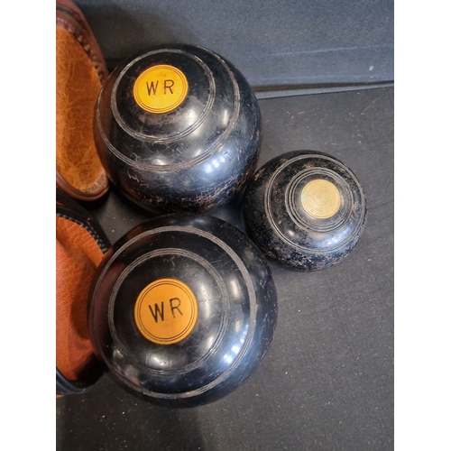 88 - A set of crown green bowling balls and Jack.  With two leather carry cases.