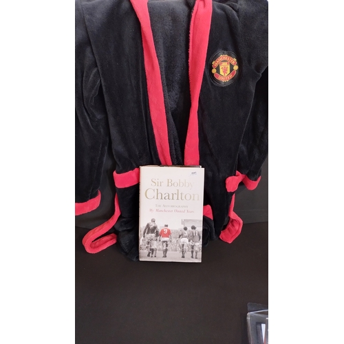 112 - Manchester United football club memorabilia. 
 Including dressing gown age 11/12, book, DVD, members... 