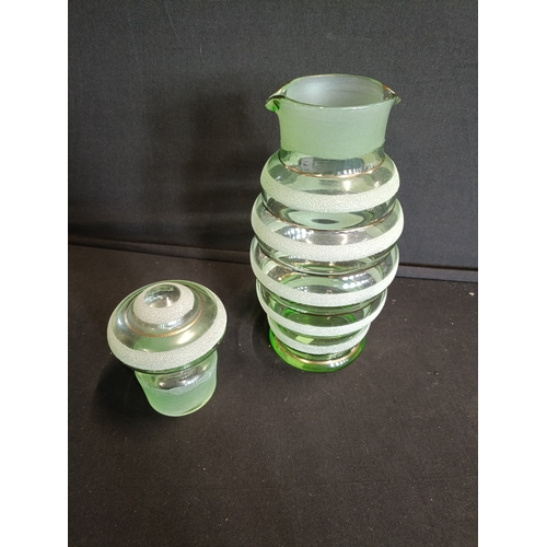 134 - Vintage art deco green glass lidded water jug with sugar frosted bands. Approximately 25cm H