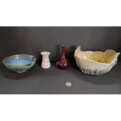 116 - Four pottery items including two small vases and two handmade stoneware dishes.
