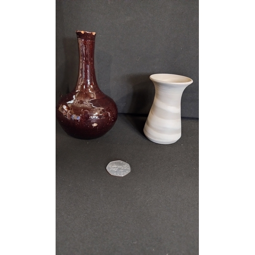 116 - Four pottery items including two small vases and two handmade stoneware dishes.