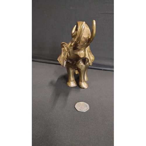 148 - Brass elephant measures 15 x 19 cm