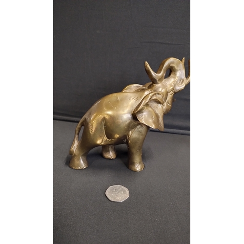 148 - Brass elephant measures 15 x 19 cm