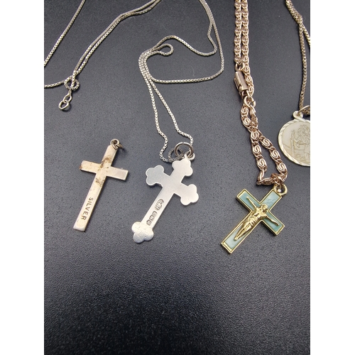 209 - Four pieces es of vintage religious jewellery. Three sterling silver crucifix and a St. Christopher.... 