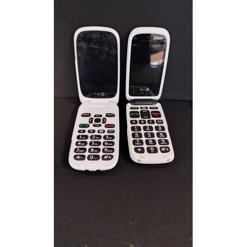 249 - Two DORO mobile phones with accessories, earphones and charges