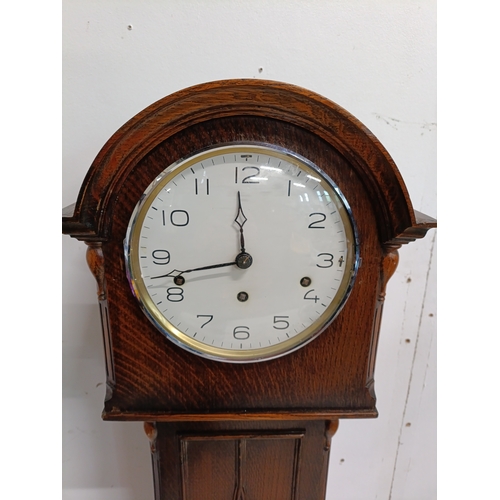 325 - Early 20th century oak long case granddaughter clock, arch moulded top, brass bezel enclosing, three... 