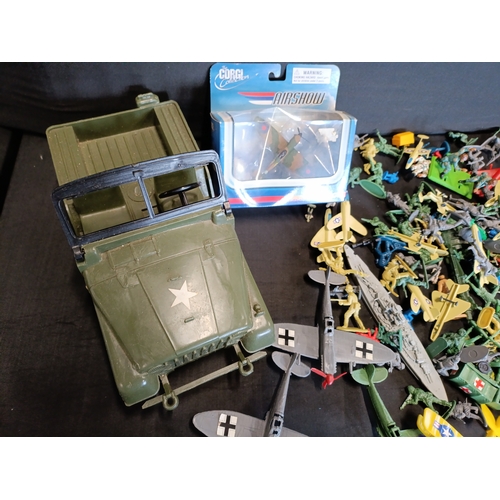 309 - Collection of military themed toys including a model Spitfire by Corgi